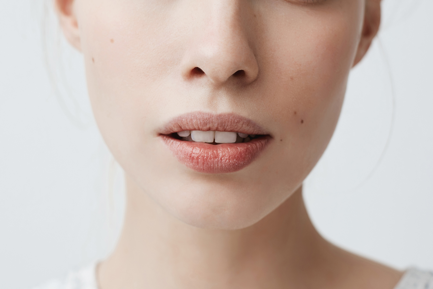 Youth, beauty and skin care concept. Close-up shot of beautiful charming young female of Caucasian appearance with porcelain pale skin and fair hair looking at camera with lips slightly parted
